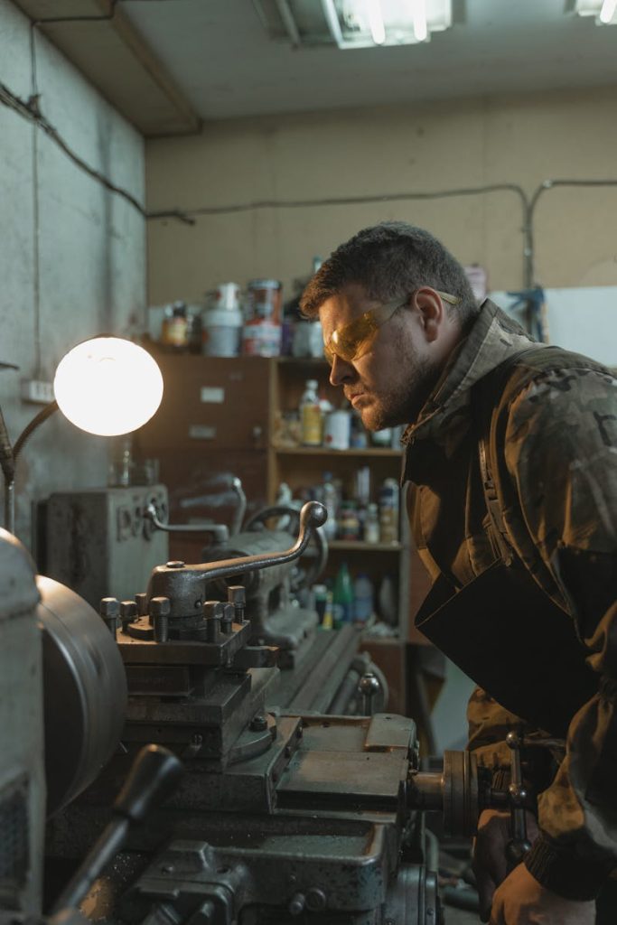 A Man Using a Lathe Machine