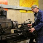 a man working on a machine in a factory