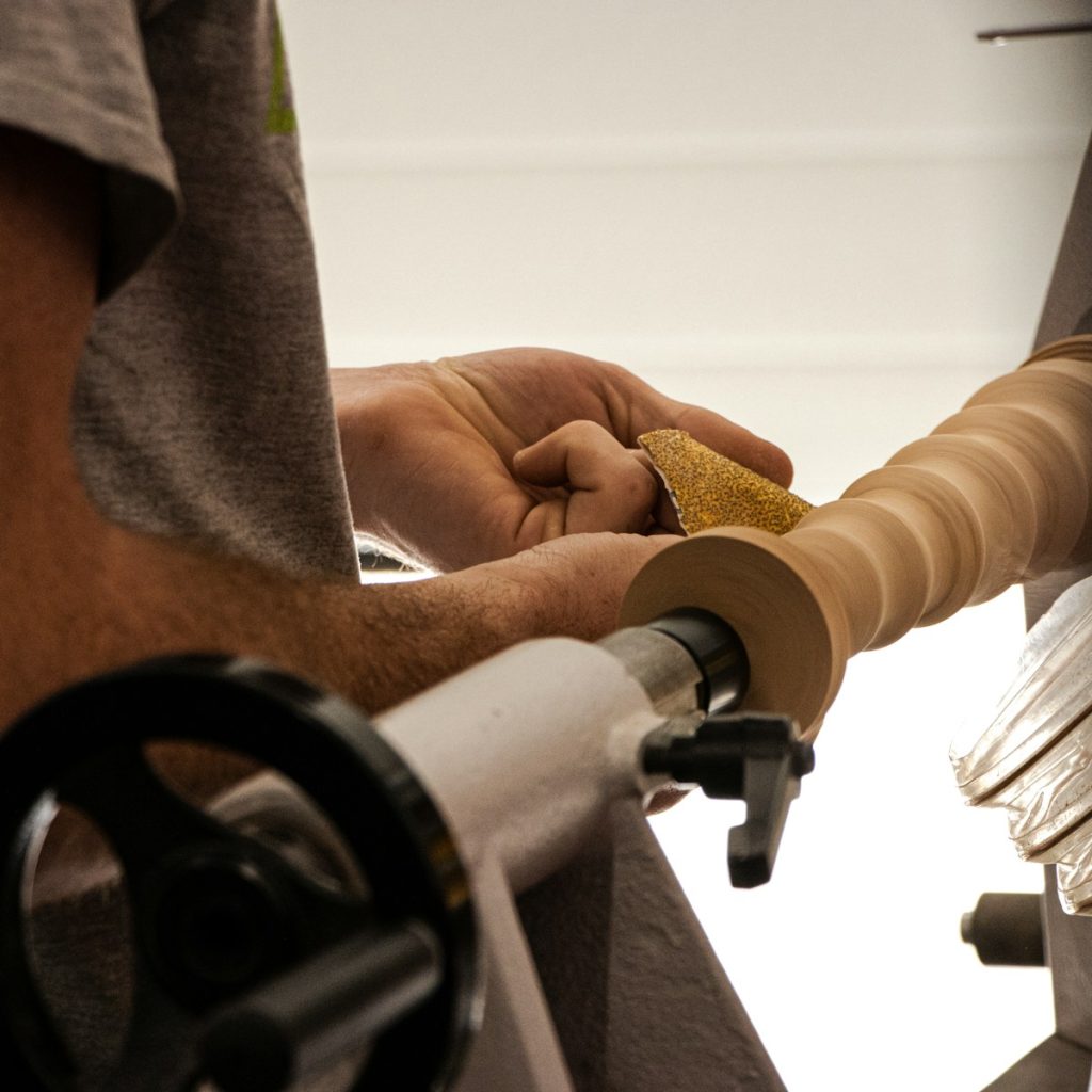 a close up of a person working on a lathe machine